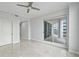 Well-lit bedroom with sliding door access to balcony, ceiling fan, neutral walls, and tile flooring at 449 S 12Th St # 1105, Tampa, FL 33602