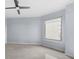 This bright bedroom features a large window, ceiling fan and neutral color palette at 449 S 12Th St # 1105, Tampa, FL 33602