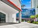 Inviting Towers entrance with palm trees and covered drop-off offers a glimpse of the building's modern design at 449 S 12Th St # 1105, Tampa, FL 33602