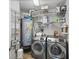 The laundry room is equipped with modern washer, dryer, shelves, and water heater at 449 S 12Th St # 1105, Tampa, FL 33602