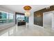 Elegant living room showcasing a chandelier, statement wallpaper, tile flooring, and a built-in fish tank at 449 S 12Th St # 1105, Tampa, FL 33602