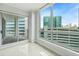 Bright living room featuring a sliding glass door to a private balcony, large windows, and tiled floors at 449 S 12Th St # 1105, Tampa, FL 33602