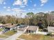 Aerial view of a home with solar panels on the roof and a driveway with a car parked at 4504 Grainary Ave, Tampa, FL 33624