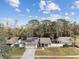 Aerial view of a well-maintained home with solar panels and a front yard at 4504 Grainary Ave, Tampa, FL 33624