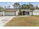 Charming single-story home with a two-car garage and well-maintained front yard at 4504 Grainary Ave, Tampa, FL 33624