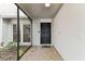 Inviting screened porch leading to the front door with adjacent garden area at 4504 Grainary Ave, Tampa, FL 33624