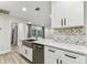 Stylish kitchen with stainless appliances, white cabinets, and sliding door to the outside at 4504 Grainary Ave, Tampa, FL 33624