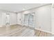 Well-lit living room with wood-look flooring and large windows at 4504 Grainary Ave, Tampa, FL 33624