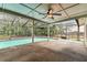 Inviting screened-in pool area with a ceiling fan for comfortable outdoor living at 4504 Grainary Ave, Tampa, FL 33624