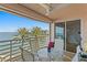 Charming balcony featuring table and seating with serene views of the bay and palm trees at 4993 Bacopa S Ln # 304, St Petersburg, FL 33715