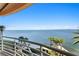 Scenic balcony view overlooking waterfront with palm trees in the distance, enhancing the space at 4993 Bacopa S Ln # 304, St Petersburg, FL 33715