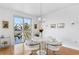 Bright dining area featuring modern white furniture and expansive water view at 4993 Bacopa S Ln # 304, St Petersburg, FL 33715