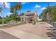 Exterior view of community's gated entry featuring meticulous landscaping and elegant architectural details at 4993 Bacopa S Ln # 304, St Petersburg, FL 33715