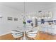 Bright open concept to dining area with white cabinetry, modern fixtures, and breakfast bar at 4993 Bacopa S Ln # 304, St Petersburg, FL 33715