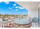 Comfortable outdoor balcony with table and seating provides beautiful views of the city at 500 Treasure Island Cswy # 404, Treasure Island, FL 33706