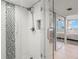 Modern bathroom featuring a glass-enclosed shower with a shower head and tiled walls at 500 Treasure Island Cswy # 404, Treasure Island, FL 33706