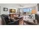 A bright living room with a view from the large sliding glass doors to the furnished outdoor balcony at 500 Treasure Island Cswy # 404, Treasure Island, FL 33706