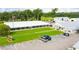 Exterior view of building with a white exterior, a green lawn, a parking lot, and an American flag out front at 5238 Mary St, Zephyrhills, FL 33542