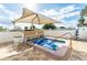 Outdoor hot tub with a large sun umbrella at 5238 Mary St, Zephyrhills, FL 33542