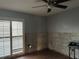 Bedroom with shuttered window and ceiling fan, showing exposed wall studs at 567 Baywood S Dr, Dunedin, FL 34698