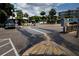 Intriguing crosswalk art on a sunny street with palm trees and nearby buildings, enhancing the neighborhood's character at 567 Baywood S Dr, Dunedin, FL 34698