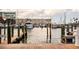 Picturesque dock view featuring various boats, calm waters, and clear skies, showcasing the waterfront lifestyle at 567 Baywood S Dr, Dunedin, FL 34698