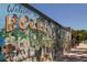 Vibrant mural of dogs on a building in Dunedin, creating a playful and artistic street view at 567 Baywood S Dr, Dunedin, FL 34698