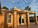 Exterior view of covered patio with columns, window, and french doors at 567 Baywood S Dr, Dunedin, FL 34698