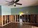 Open-concept living room with partially exposed walls and modern ceiling fan at 567 Baywood S Dr, Dunedin, FL 34698