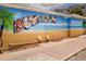 Whimsical Dunedin mural featuring beach scenes, inviting residents to explore local culture, and welcome them to the community at 567 Baywood S Dr, Dunedin, FL 34698