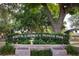 Entrance to John R. Lawrence Pioneer Park with lush greenery, signage, and serene landscaping at 567 Baywood S Dr, Dunedin, FL 34698