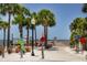 Charming Clearwater Ferry pier view featuring palm trees, a whimsical dolphin statue, and waterfront access at 567 Baywood S Dr, Dunedin, FL 34698