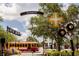 Charming Dunedin street scene with trolley, businesses, and local signage under a sunny sky at 567 Baywood S Dr, Dunedin, FL 34698