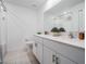 Bright bathroom featuring double sinks, white cabinetry, and tile flooring at 6256 Shiner St, Land O Lakes, FL 34638