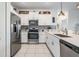 Stylish kitchen featuring white cabinetry, stainless steel appliances, and a sleek quartz countertop at 6256 Shiner St, Land O Lakes, FL 34638