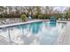 Inviting community pool with lounge chairs and waterfall feature, perfect for relaxation and recreation at 6256 Shiner St, Land O Lakes, FL 34638