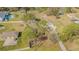 Aerial view of the home on a sprawling lot surrounded by mature trees at 7301 Avocet Dr, Wesley Chapel, FL 33544