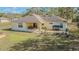 Aerial view of the home's backyard showing covered patio and ample green space at 7301 Avocet Dr, Wesley Chapel, FL 33544