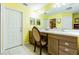 Vanity area with a large mirror, storage cabinets, and a decorative chair at 7301 Avocet Dr, Wesley Chapel, FL 33544