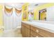 Bathroom featuring a sink and vanity with decorative gold curtains at 7301 Avocet Dr, Wesley Chapel, FL 33544