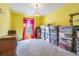 Carpeted bedroom featuring a window with red curtains and ample storage space at 7301 Avocet Dr, Wesley Chapel, FL 33544