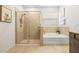 Well-lit bathroom showcases separate shower and soaking tub at 7324 Steer Blade Dr, Zephyrhills, FL 33541