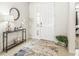 Welcoming foyer featuring a console table, decorative mirror, and views into the main bedroom at 7324 Steer Blade Dr, Zephyrhills, FL 33541