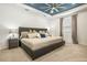 Spacious main bedroom featuring a tray ceiling and large windows at 7324 Steer Blade Dr, Zephyrhills, FL 33541