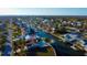 Aerial waterfront view of the home featuring a canal and private boat dock at 7623 Mako Dr, Hudson, FL 34667