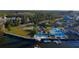 Aerial waterfront view of the home featuring a pool, backyard, and private boat dock at 7623 Mako Dr, Hudson, FL 34667