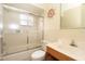 Bright bathroom featuring a tiled shower with glass doors and a traditional vanity at 7623 Mako Dr, Hudson, FL 34667