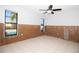 Bedroom featuring large windows and tile flooring, currently under renovation with exposed wall framing at 7623 Mako Dr, Hudson, FL 34667