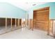 Hallway showcasing cedar closet and tile flooring while undergoing renovation with exposed wall framing at 7623 Mako Dr, Hudson, FL 34667