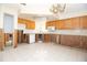 Kitchen with wood cabinetry and white appliances, currently under renovation and remodeling at 7623 Mako Dr, Hudson, FL 34667